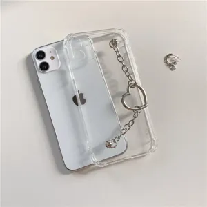 Clear phone case with a metal heart chain bracelet, minimalist aesthetic for iPhone models.