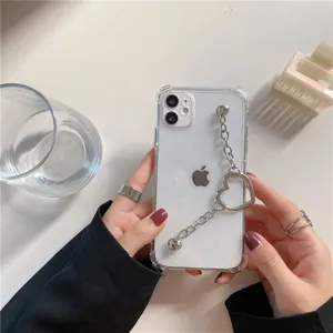 Clear phone case with metal heart chain wristband, protective cover for iPhone models.