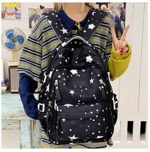 Detailed view of a large-capacity black star print student backpack, perfect for casual commuting.