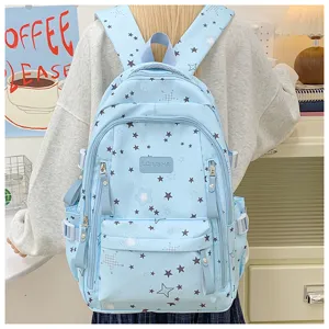 Detail view of light blue school backpack with cute star pattern, spacious compartments.