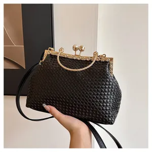 Black woven kiss-lock shoulder bag with metal frame and top handle for women daily commute.