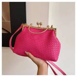 Detailed view of pink woven clutch bag with gold kiss-lock frame and sparkling rhinestone handle.