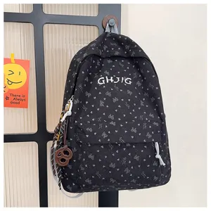 Detailed view of the black corduroy backpack featuring bow heart prints and GHJIG letter embroidery.