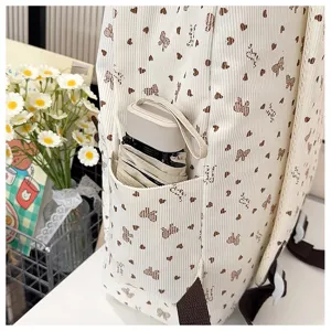 Detailed view of the cute corduroy backpack side pocket with bow print and folding umbrella.
