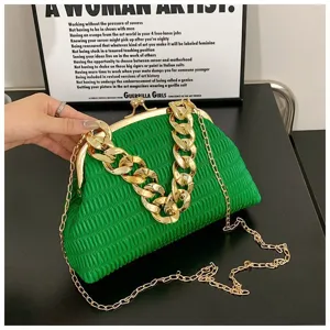 Green pleated clutch bag with chunky gold chain detail, elegant evening shoulder bag style.