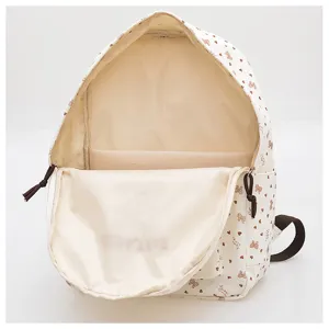 Casual backpack with cute bow and heart print, features durable straps and spacious interior.
