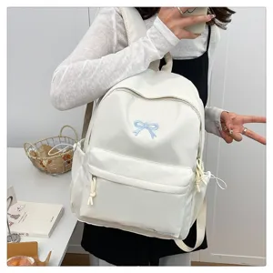 Sweet Japanese style white backpack with cute blue bow embroidery for school girls daily use.