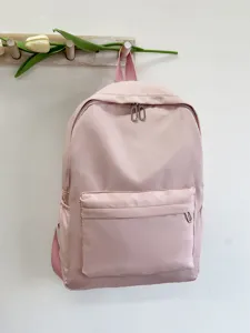 Dettaglio zaino da scuola rosa casual, design minimalista a tinta unita con tasca.