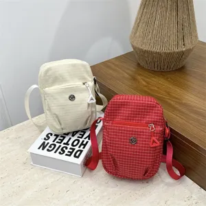 Casual grid crossbody bag for women, stylish square shoulder bag with zipper front pocket.