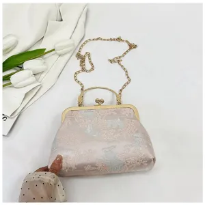 Detailed view of traditional Chinese style brocade handbag with metal frame and chain.