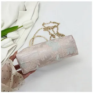 Elegant Chinese style cylindrical handbag with delicate printed pattern and metal chain.