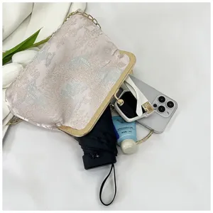 New Guofeng satin clutch bag with vintage landscape pattern and elegant gold frame detail.