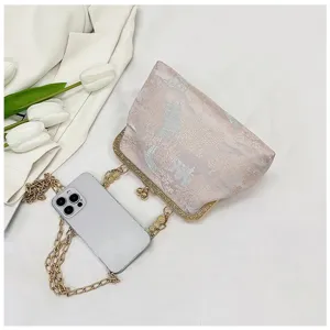 Exquisite Chinese style brocade kiss-lock clutch bag detail shot with elegant metal chain.