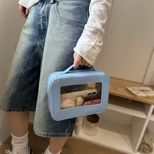 Borsa cosmetica blu chiaro con finestra trasparente custodia per trucco da viaggio.