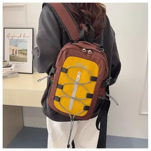 Colorblocked casual backpack for travel and outdoor activities with front bungee cord design.