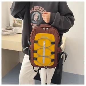 Detailed view of the stylish color-blocked backpack with bungee cords and multi pockets for travel.