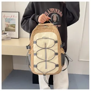 Color-block casual backpack with bungee cords and multi-pockets for travel and daily use.