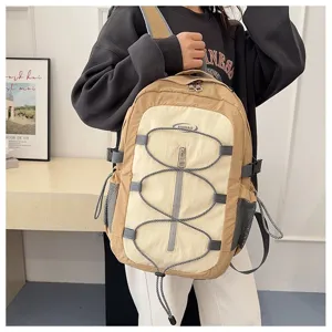 Detailed closeup shot of a stylish contrast color casual backpack with bungee cords.