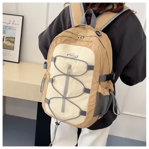 Detailed view of casual colorblock backpack with elastic bungee cords and front zip pocket.
