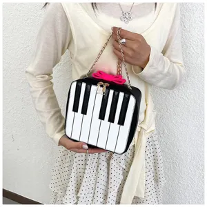 Chic piano keys crossbody bag detail, cute mini shoulder bag with chain strap and bow.