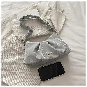 Detailed view of the trendy ruched cloud shoulder bag in stylish gray marble pattern.