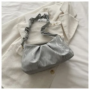 Detail view of stylish grey ruched cloud shoulder bag with minimalist design for daily wear.
