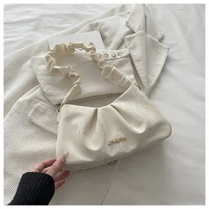 Detailed view of women pleated cloud shoulder bag, chic minimalist PU leather design underarm bag.