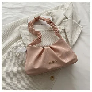 Pink ruched shoulder bag detail, elegant cloud design with pearl lace pendant and metal logo.