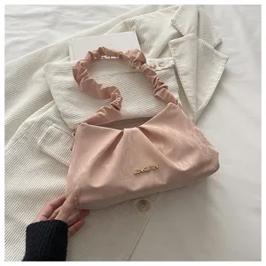 Korean style cloud gathered underarm bag detail, pink shoulder bag with metal logo and pleated look.