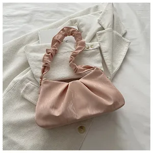 Detailed view of the pink ruched cloud shoulder bag, showing the unique gathered design.