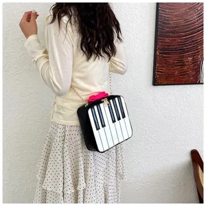 Chic piano keys design mini crossbody bag with chain strap and cute bow, stylish shoulder bag.