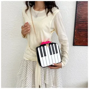 Detailed view of the creative piano keys crossbody bag showcasing its unique design and chain.