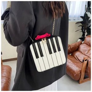Close-up detail of a creative piano keys design mini crossbody bag with a chic bow.