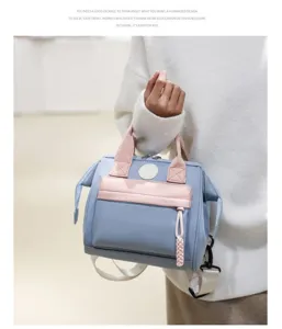 Stylish multi-functional mommy backpack in blue and pink, perfect for daily travel.