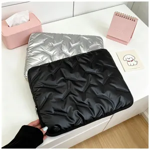 Detailed view of fashionable quilted PU leather laptop sleeve and document bag with glossy finish.