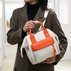 Stylish canvas mommy shoulder bag with contrast orange and white design for modern mothers.