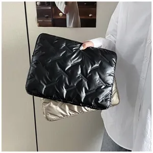 Detail view of the glossy embossed PU leather laptop sleeve and large capacity clutch bag.