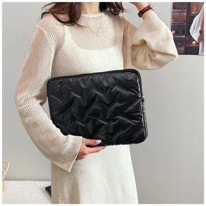 Glossy embossed soft PU large capacity clutch bag detail showing texture and hand holding style.