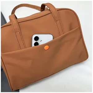 Detailed view of large capacity brown canvas tote bag front pocket casual shoulder bag