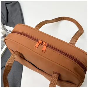 Brown nylon tote bag detail zipper handle commuting casual daily use practical design pocket accessory