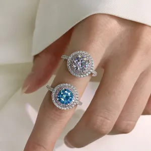 Detail shot of S925 silver double halo micro-inlaid rings with blue and clear simulation diamonds.