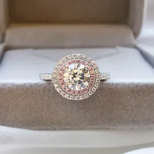 Detailed close-up of double halo pink and white diamond ring set in silver, sparkling micro-pave band