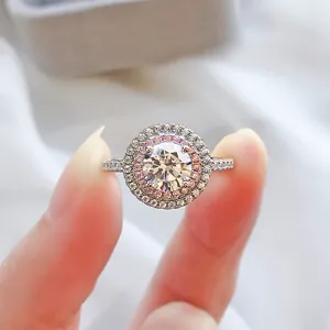 Close-up of a sparkling S925 silver halo ring with pink and white pavé stones.