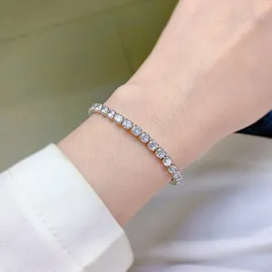 Primo piano dettagliato di un bracciale tennis in diamante simulato scintillante al polso.