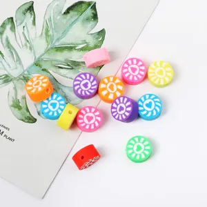 Colorful polymer clay beads with sun and heart patterns, perfect for DIY jewelry making.