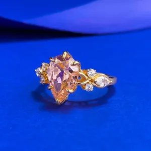 Pear-cut padparadscha color gemstone ring in S925 silver with sparkling side cubic zirconia stones.