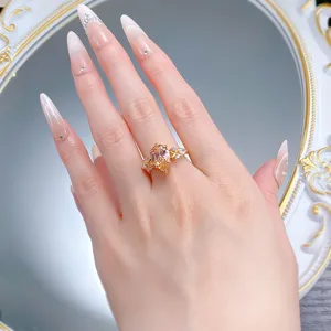 Close-up detail of a stunning pear-shaped peach stone ring with sparkling side stones.