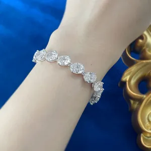Close-up detail of a stunning oval-cut crystal silver tennis bracelet worn on the wrist.