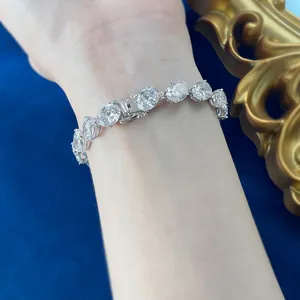 Detailed close-up of a luxurious oval cubic zirconia tennis bracelet worn on wrist.