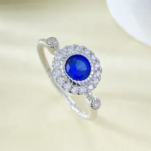 Vista dettagliata dell'anello in argento 925 placcato oro con zaffiro blu rotondo da 5 mm e corona.